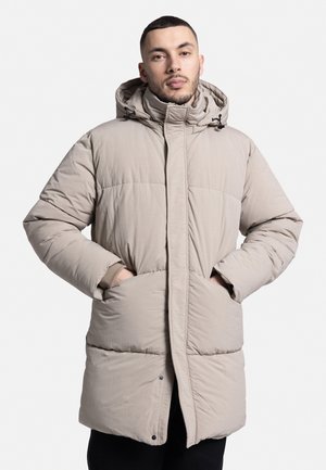Beige padded jacket with a hood, front zipper, and side pockets. Features a quilted design and elastic cuffs for warmth.