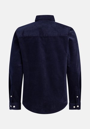 Marinblå kordflodsskjorta med ryggsömn, långa ärmar, knäppte manschetter och rundad nederkant med ribbad textur.