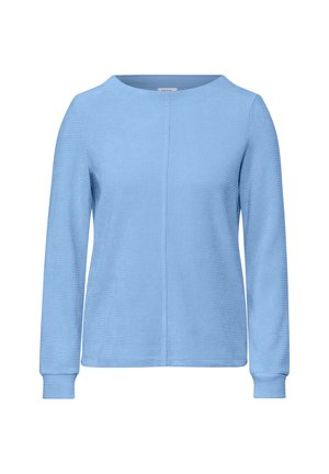 Top azzurro chiaro a maniche lunghe con scollo rotondo, tessuto testurizzato e dettaglio della cucitura che corre lungo il centro. Polsini a costine.