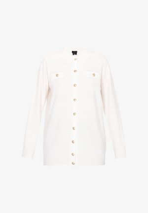 Witte cardigan met een gestructureerd patroon, lange mouwen en gouden knopen. Bevat twee kleine borstzakken en een ronde halslijn.