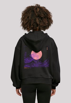 Black hoodie with a large purple graphic depicting waves and a pink moon on the back. Features a relaxed fit and soft fabric texture.