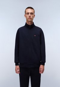 Navy zip-up jacket with high collar and elastic cuffs. Features a small logo on the chest. Smooth fabric with a relaxed fit.
