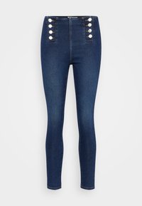Jeans de denim de tiro alto en azul oscuro, que cuentan con botones delanteros, un diseño ajustado y una textura suave y ligeramente elástica.