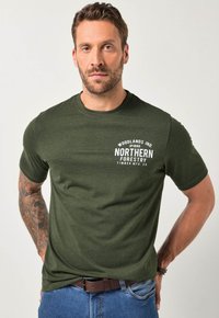 Zelené bavlněné tričko s krátkými rukávy, kulatým výstřihem a bílým potiskem "Severní lesnictví" na přední straně.