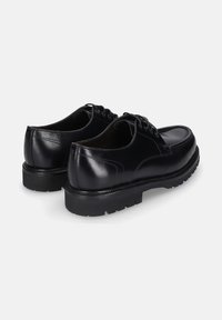 Zwarte leren schoenen met een gladde afwerking, ronde neus en dikke zwarte rubberen zool. Voorzien van veters en subtiele stiksels.