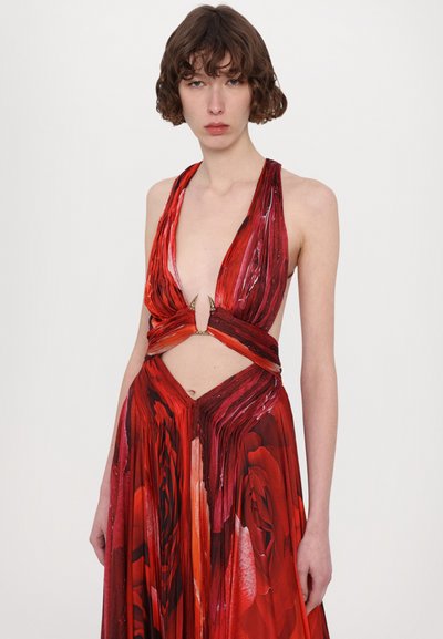 Red floral dress with a deep V-neck, cut-out waist, and pleated design. Features a metallic accent at the center.