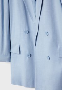 Blazer doppiopetto azzurro chiaro, caratterizzato da due grandi bottoni, revers a forma di notched e un tessuto testurizzato. Include tasche anteriori a patta.