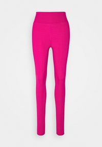 Kirkkaan vaaleanpunaiset korkeavyötäröiset legginssit, joissa on saumatön muotoilu ja kapea malli, esiteltynä yksinkertaisen vaalean taustan edessä.