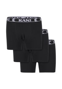 Trīs melni bokseršorti sakrauti, katram ar melnu un baltu jostu, kas rotāta ar "KANI" zīmolu.