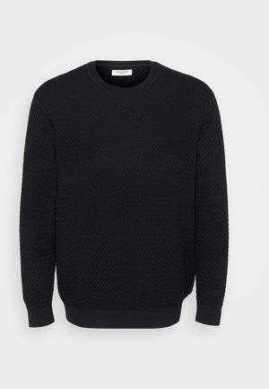 Must mustri kootud sviiter tekstureeritud pinna, ümmargune kaelus, pikad varrukad ning ribakujulised mansetid ja allserv. Logo ega muid nähtavaid detaile ei ole.