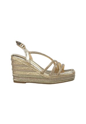 Gold platform wedge sandal with multiple crisscross straps, textured woven jute sole, and metallic accents. Adjustable ankle strap.