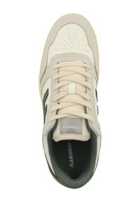 Sneaker with a cream and grey leather upper, perforated toe, beige laces, black accents, and a textured black sole. Logo on the tongue.