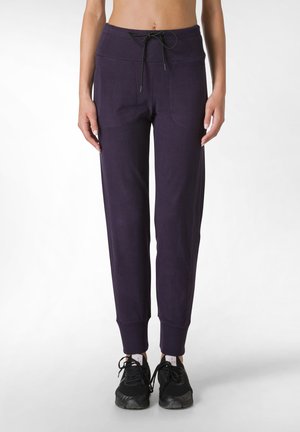 Pantaloni della tuta viola con vita regolabile, polsini a coste e tasche laterali. Realizzati in un tessuto morbido, progettati per comodità e abbigliamento casual.