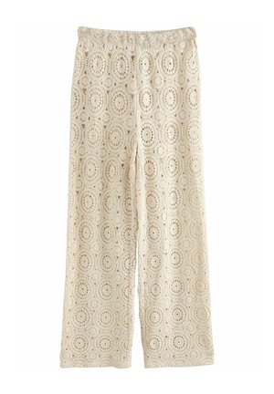 Kanten broek in lichtbeige met een cirkelpatroon, wijd uitlopende pijpen en een elastische tailleband voor comfort en gemak bij het dragen.