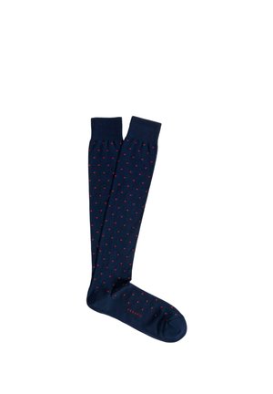 Calzini al ginocchio blu navy con piccoli pois rossi e polsini a coste, mostrati distesi su uno sfondo bianco.