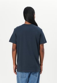 Navy blue cotton t-shirt with a classic crew neck, short sleeves, and a relaxed fit, featuring a smooth texture and no visible graphics.