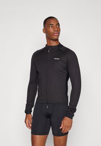 Schwarzes Langarm-Radtrikot mit Reißverschluss und figurbetontem Design. Mit einem Logo auf der Brust und leichten, dehnbaren Stoff.