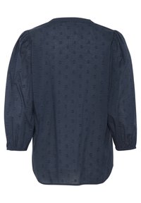 Blouse bleu foncé en tissu léger, présentant un motif discret de cœurs, des manches bouffantes et un col rond.