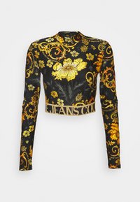 Svart långärmad crop top med gyllene blommönster och utsmyckning. Har en djärv "JEANS COURT"-logotyp i guld på nederkanten.