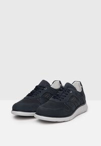 Scarpe da ginnastica blu navy realizzate in tessuto testurizzato e pelle, con suola bianca, punta rotonda e lacci coordinati con perforazioni laterali.