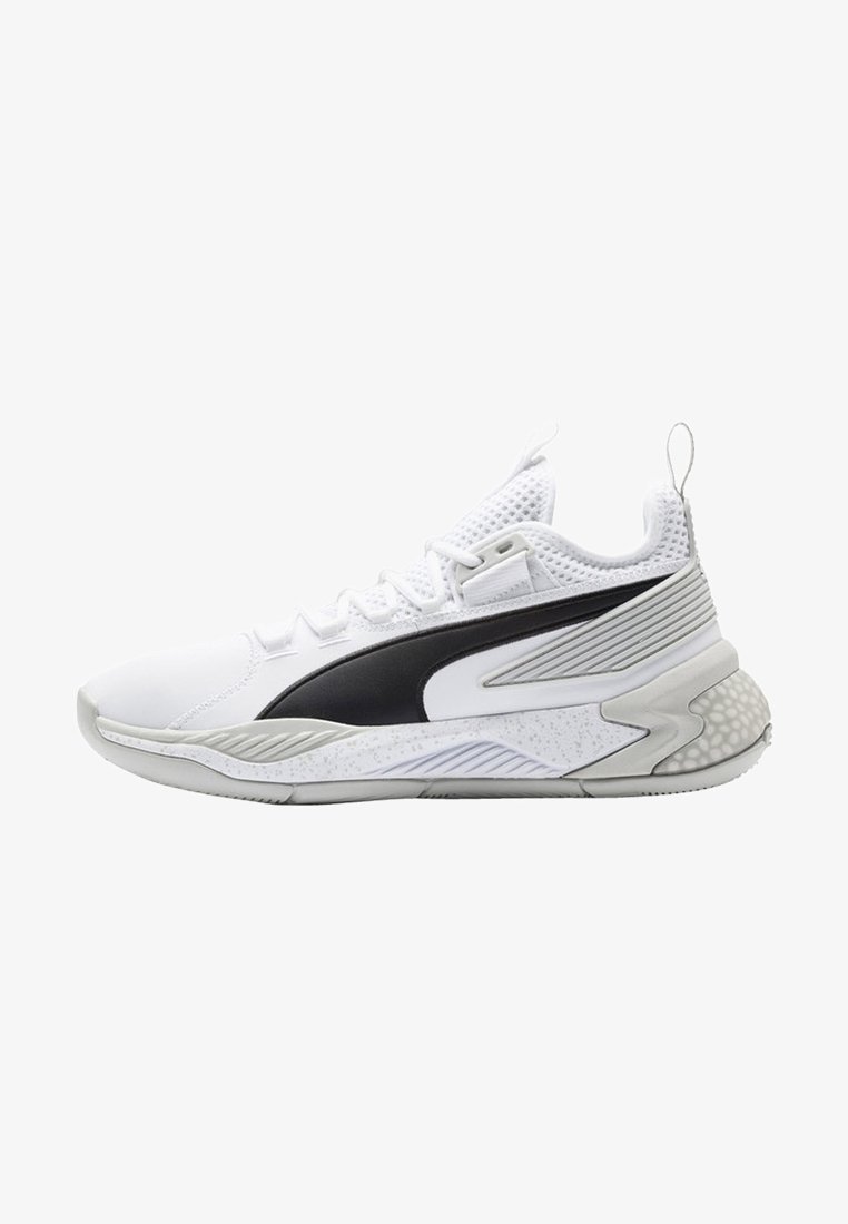 Biały but sportowy z czarnym bocznym paskiem, siateczkowymi akcentami, teksturowaną podeszwą i miękką środkową podeszwą z nakrapianym wzorem.