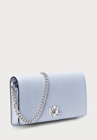 Borsa a tracolla blu chiaro con texture, dotata di una catena argentata e un dettagliato logo argento prominente sulla parte anteriore. Forma rettangolare, bordi lisci.