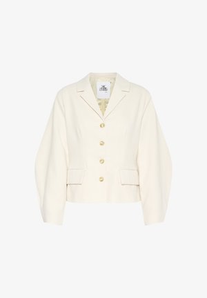 Krém színű, rövidített szabású dzseki, struktúrált gallérral, hosszú ujjal és nagy gombokkal. Elöl zsebekkel és textúrált anyaggal rendelkezik.