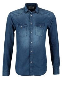 Tummansininen pitkähihaisen farkkupaita, jossa on kaksi rintataskua, napitettava sulku ja pyöristetty helma. Sileä pinta, jossa hillitty haalistuma.