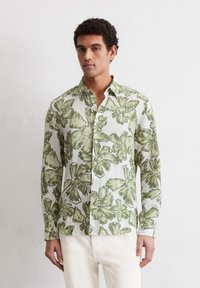 Long-sleeve shirt in lightweight fabric, featuring green floral patterns on a white background, button-up design, and a classic collar.