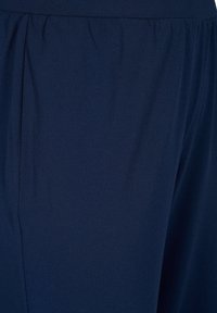 Navy blue fabric with a smooth, soft texture, featuring a gathered elastic waistband and subtle vertical seams for design detail.