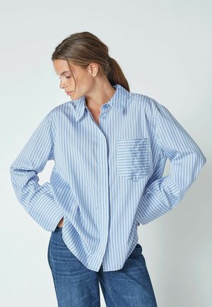 Blue and white striped button-up shirt with long sleeves and a chest pocket. Soft fabric with a relaxed fit and pointed collar.