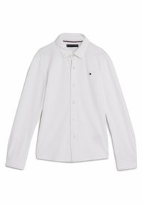 Camicia bianca a maniche lunghe con bottoni, realizzata in tessuto morbido, caratterizzata da un colletto classico, logo discreto sul petto e maniche con polsini standard.