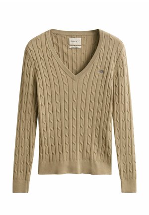 Beige kabelstrikket V-hals genser med lange ermer, ribbestrikkede mansjetter og kant, samt en liten brodert logo på brystet.