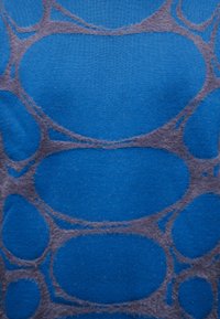 Blue fabric with a pattern of large and small interconnected oval shapes in a darker tone, creating a textured, abstract design.