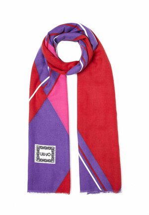 Czerwony, fioletowy i różowy szalik z geometrycznym wzorem, białymi paskami i małą kwadratową metką z logo na jednym końcu.