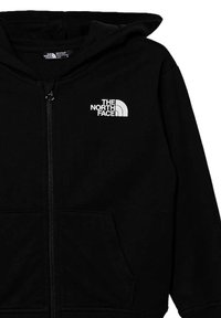 Felpa nera con zip realizzata in tessuto morbido. Presenta un logo bianco sul lato sinistro del petto, tasche frontali e un cappuccio regolabile con cordino.