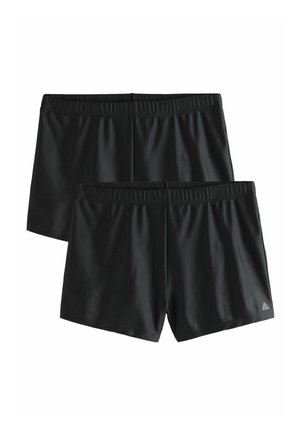 Două perechi de pantaloni scurți sport negri cu talie elastică, design simplu și un mic logo triunghiular pe un picior, afișate pe un fundal alb.