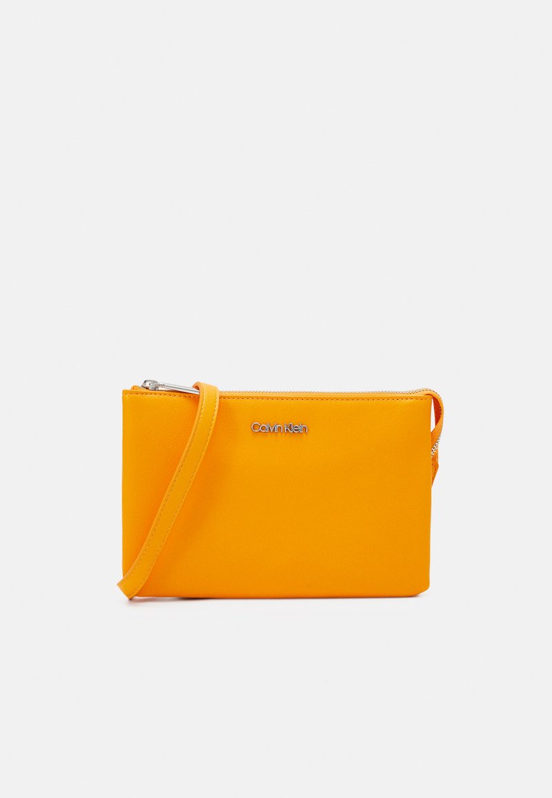 Calvin Klein MUST XBODY Across body bag orange flash/orange