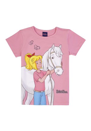 Girl with blonde ponytail in pink shirt and blue pants holding a white horse's reins, with two butterflies above and "Bibi & Tina" text.