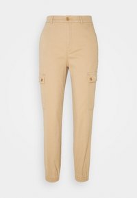 Beige cargobyxor med elastiska muddar, två sidofickor, knappar och en mjuk bomullstextur.