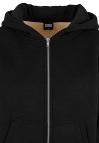 Felpa nera con cerniera argentata, tasche anteriori e cappuccio interno foderato. Realizzata in tessuto morbido con una trama liscia. Etichetta visibile all'interno.
