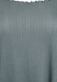 Gray ribbed knit top with a scalloped neckline, featuring vertical stripes and small diamond patterns throughout. Soft texture.