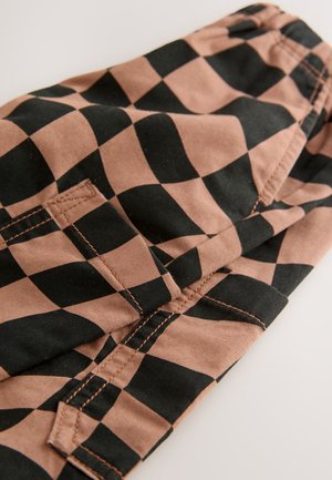 Cotton fabric in a brown and black checker pattern with visible stitching and pocket detail, featuring a smooth texture and tailored shape.