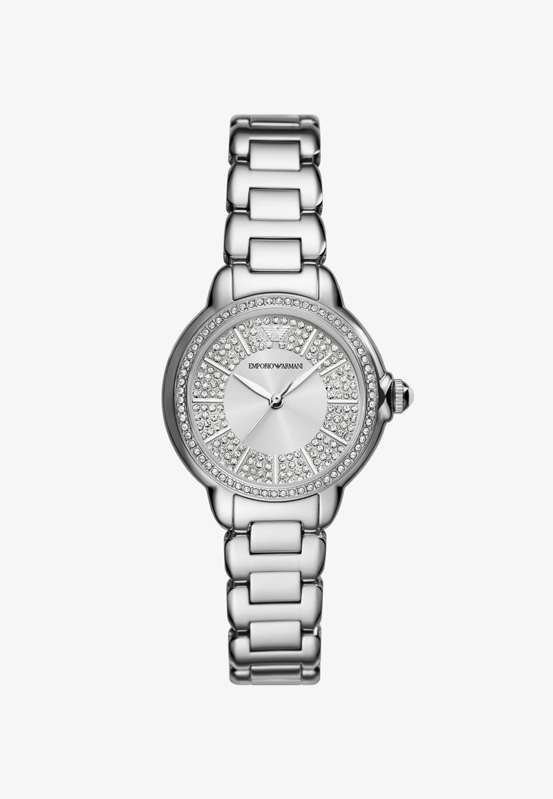 Srebrny zegarek metalowy z okrągłą tarczą, ozdobami z kryształków i polerowanym bransoletą z ogniw. Posiada prostą tarczę i koronkę.