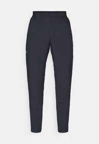 Schwarze Sporthose mit glatter Textur, schlankem Schnitt, elastischem Bund und seitlichen Taschen. Mit einem kleinen Logo auf dem linken Oberschenkel.