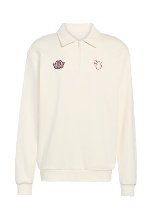 Cremefarvet polo-sweatshirt med lynlåslukning ved kraven, ribstrikkede manchetter og bordeauxfarvede broderede detaljer inklusive et logo og initialer.