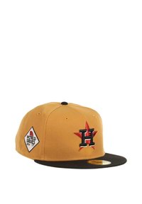 Baseball cap with a tan crown, black visor, embroidered red star and letter "H," and a white diamond patch reading "World Series 2017."