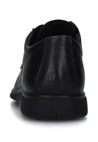 Scarpe nere in pelle con una superficie liscia, forma arrotondata e tacco basso. Presentano cuciture sottili e un piccolo manico sul retro.