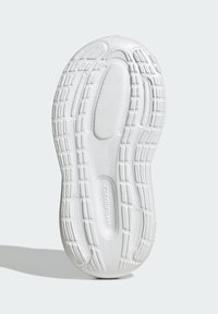 White sneaker outsole featuring textured rubber with varying grips and contours, marked with "CLOUDFOAM" on the side.