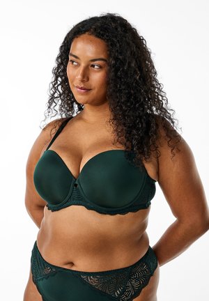 Dark green bra with smooth, molded cups, lace trim, and adjustable straps, paired with matching lace-accented panties.